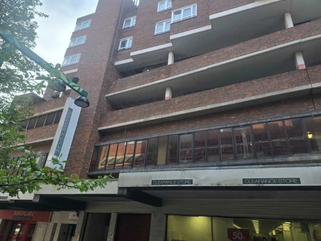 Brick block of flats above a row of shops